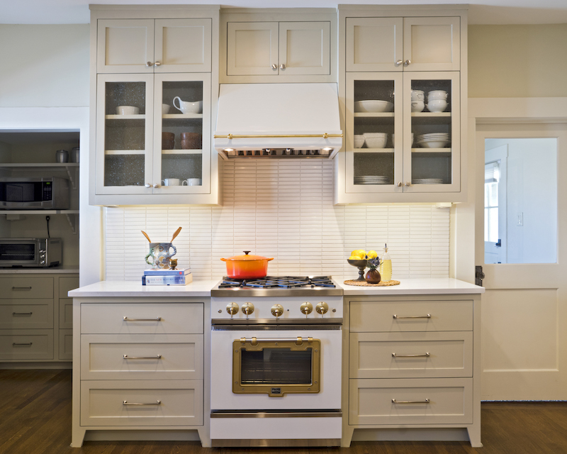 A scullery just off of the kitchen keeps small appliances on countertops for daily use, but out of sight. Backsplash tile from Fireclay. Cabinet and door hard-ware from Alexander Marchant. Range from Big Chill.