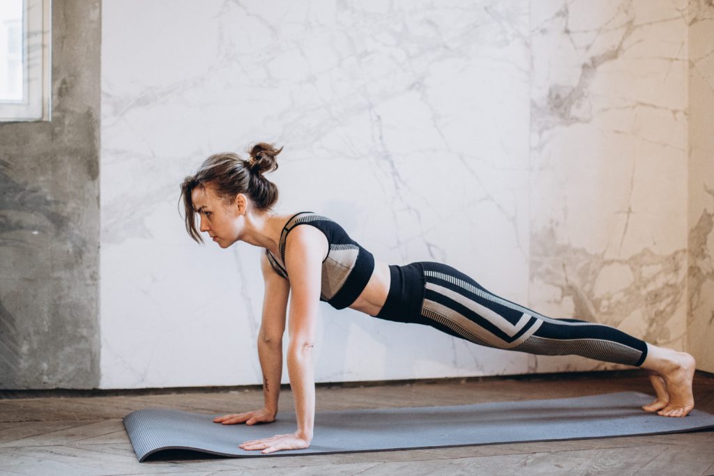 woman in black tank top and black leggings doing yoga 3822365