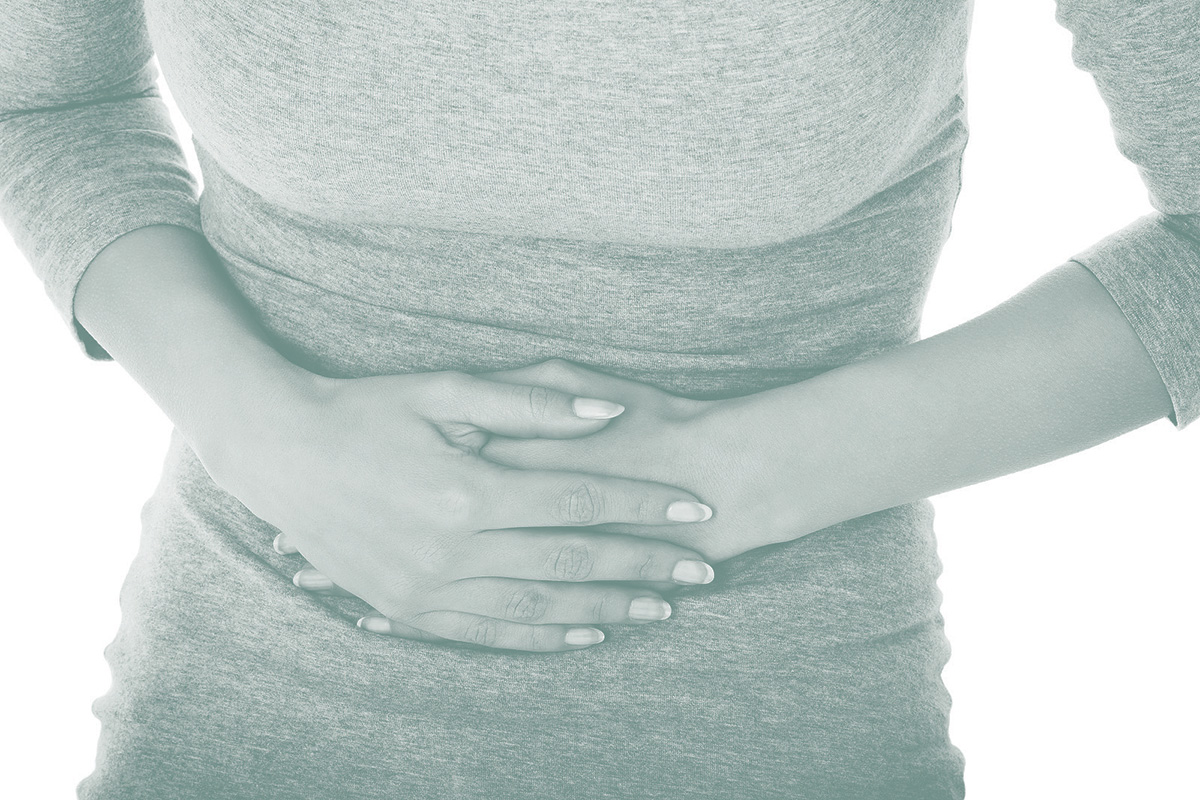 Young casual woman is having stomach ache.
